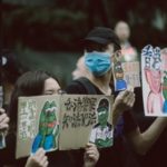 Hong Kong protesters wearing facemasks and their boards to devoid of a legal system.