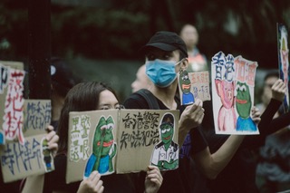Hong Kong protesters wearing facemasks and their boards to devoid of a legal system.