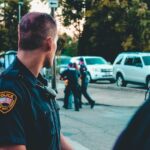 Police officer looking back on his 2 co-workers arresting a person and as the featured image of "derek michael chauvin's jury verdict and sentencing" blog.