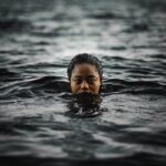 Closed-up of a woman floating on a sea-water and as the featured image of "abuse and sexual complaints swimming australia" blog.